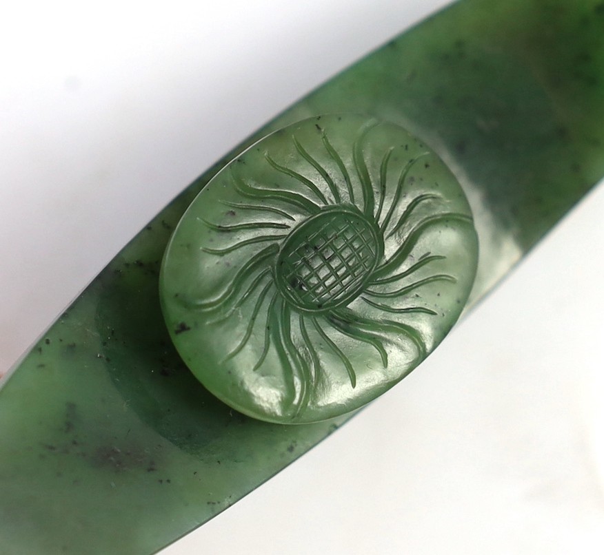A Chinese bright spinach green jade ‘dragon’ belt hook, 18th/19th century, 9.5cm long